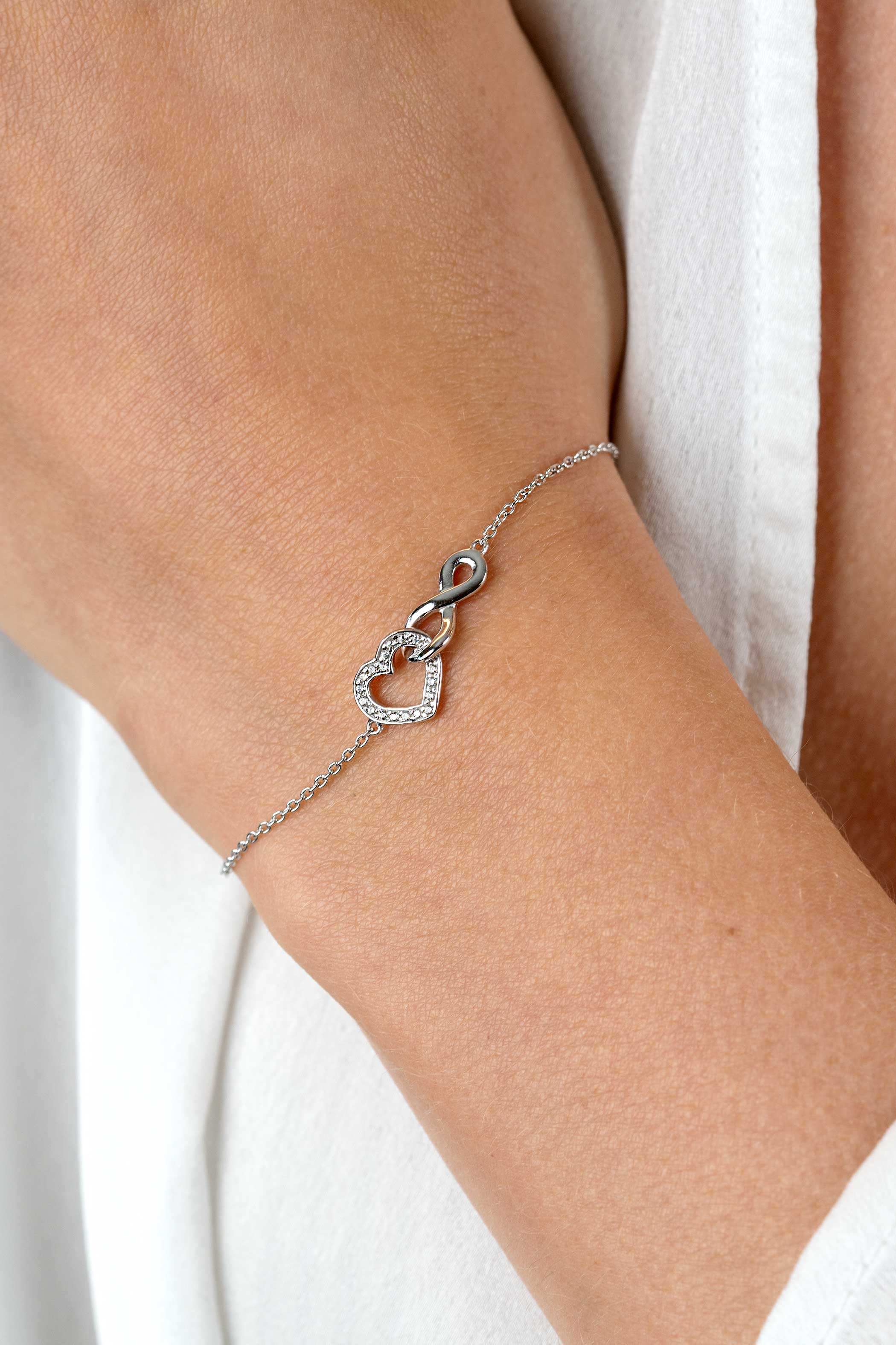 ZINZI silver bracelet with Infinity sign connected with an open heart, set with white zirconia 17-19cm ZIA2596