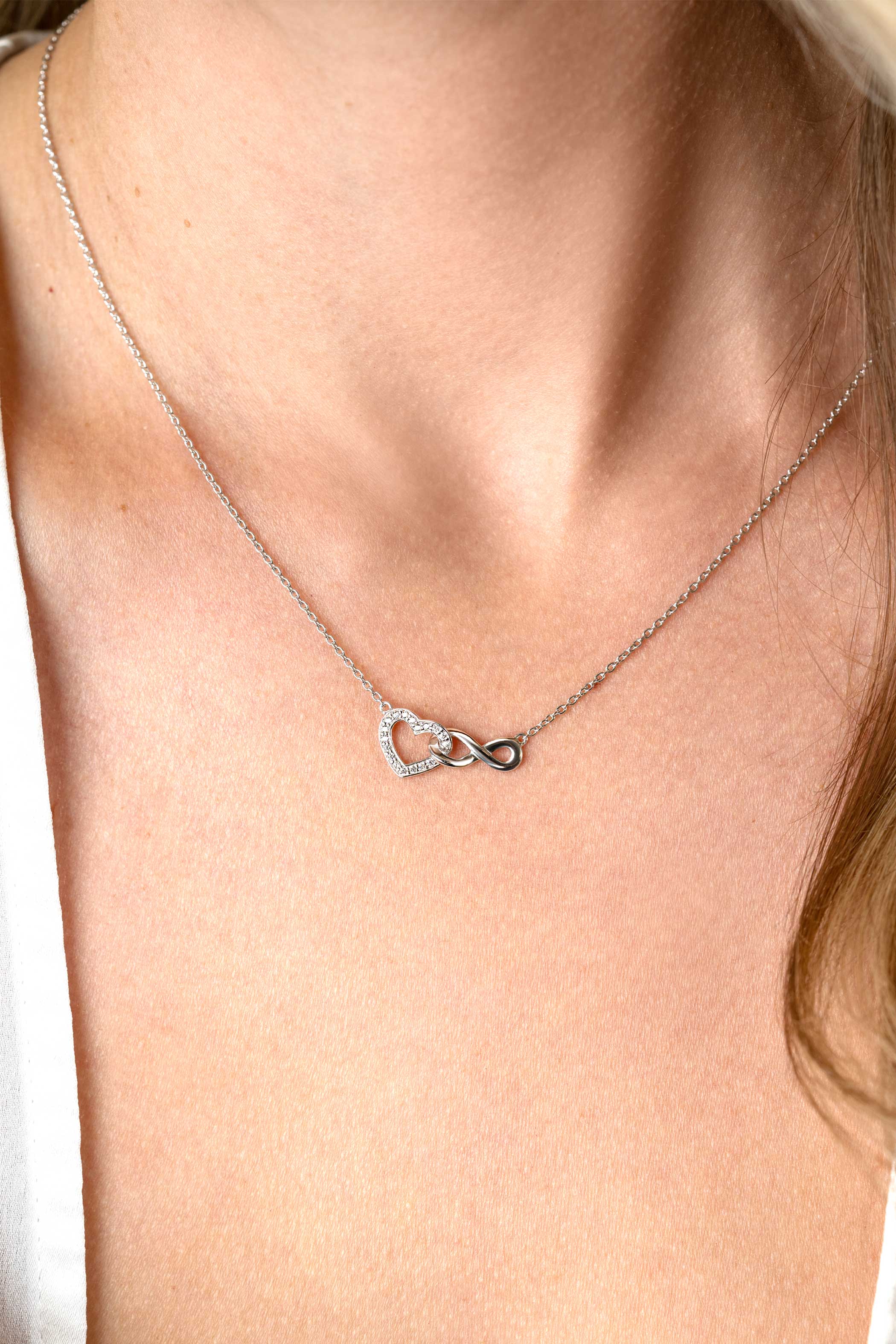 ZINZI silver necklace with Infinity sign connected with an open heart, set with white zirconia 42-45cm ZIC2596